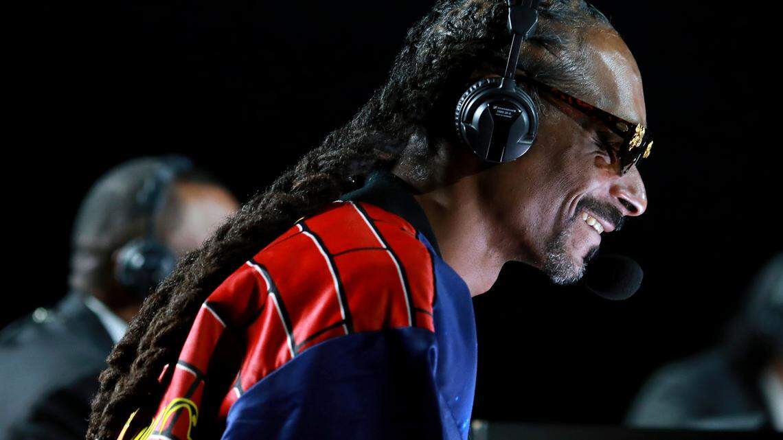 In a photo provided by Triller, Snoop Dogg performs onstage at an exhibition boxing bout between Mike Tyson and Roy Jones Jr. on Saturday, Nov. 28, 2020, in Los Angeles. The bout was unofficially ruled a draw by the WBC judges at ringside. Tyson and Jones fought eight two-minute rounds, and both emerged smiling and apparently healthy from a highly unusual event. (Joe Scarnici/Triller via AP)