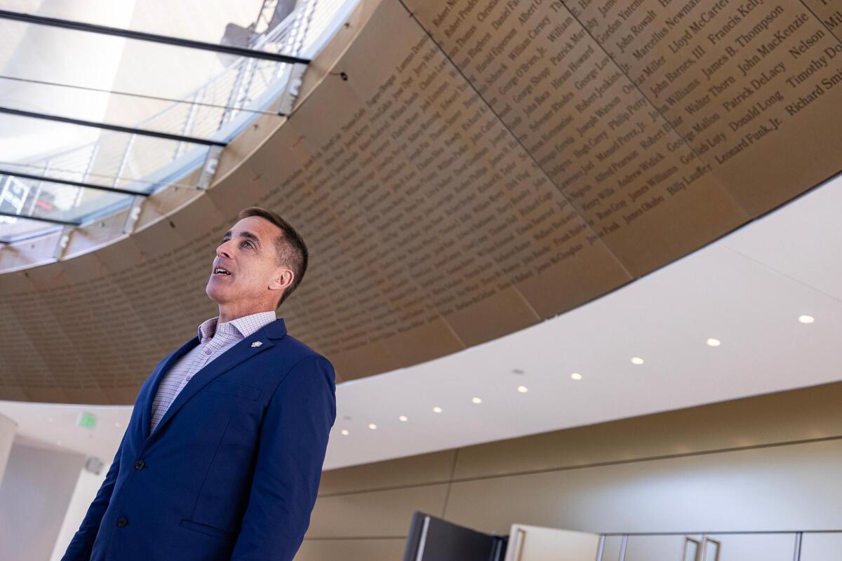 Chris Cassidy, the National Medal of Honor Museum president and CEO, addresses the media with a backdrop of the thousands of names of Medal of Honor recipients, during a media preview event at the Medal of Honor Museum in Arlington on Wednesday, March 19, 2025.