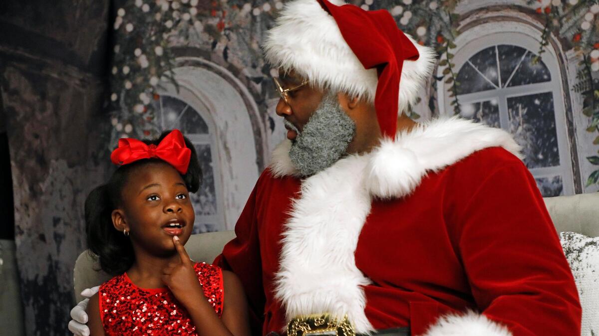 Caiden Black, 7, visits Santa Justin, aka Justin Peach, at Chaunva LeCompte Photography in Mansfield. Caiden wanted only one gift. She would not tell anyone else because it was a secret.