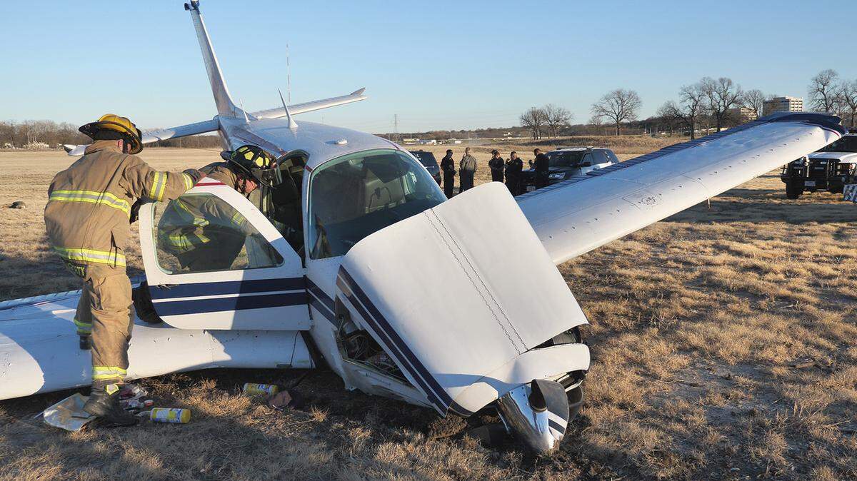 Fort Worth firefighters look over a plane that developed engine issues sunday afternoon. The plane made an emergency landing in a field off of Beach St. and I-30. Medstar treated the 2 people on board for minor injuries. No other info was immediately available.(Special to the Star-Telegram/Glen E. Ellman)No Sales