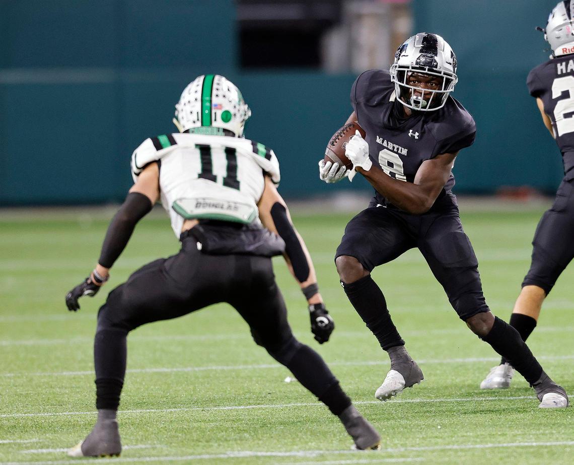 Martin running back Javien Toviano (8) gets the first down around the right side during a Conference 6A Division 1 regional playoff football game at Globe Life Park in Arlington, Texas, Friday, Dec. 24, 2020. Southlake Carroll defeated Arlington Martin 30-26. (Special to the Star-Telegram Bob Booth)