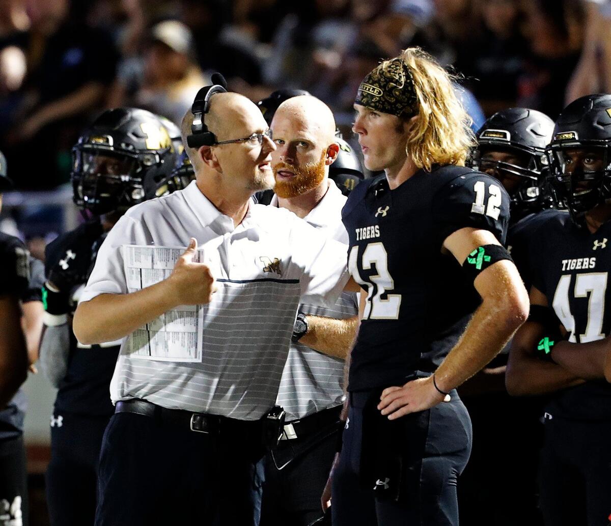 Mansfield head coach Daniel Maberry talks with quarterback Hunt Young (12) on the sidelines late in the first half of a high school football game at Vernon Newsom Stadium in Mansfield, Texas, Friday, Sept. 20, 2019. With 27 seconds remaining in the first half Mansfield took the lead 14-7. (Special to the Star-Telegram Bob Booth)