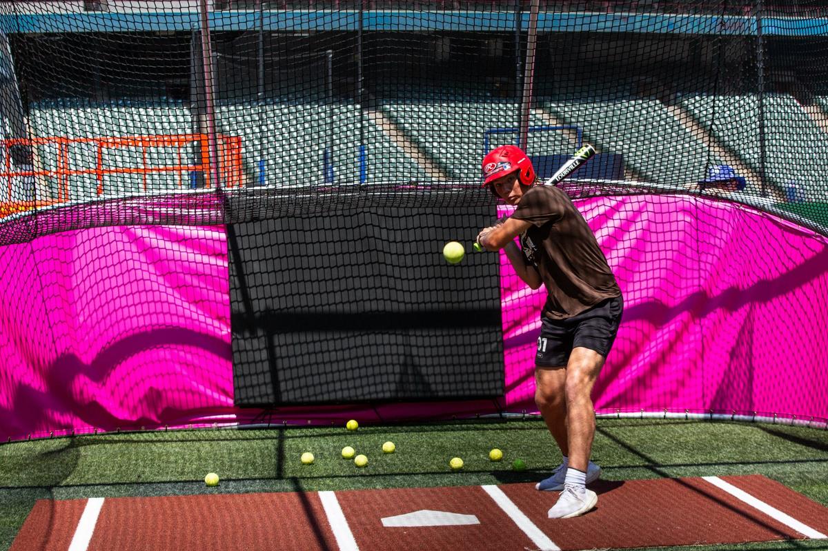 Christian Lux, 14, swings the bat in a batting cage during the All-Star Village hard hat tour on Thursday, July 11 at the Choctaw stadium in Arlington. Guests have the opportunity to take a swing in the batting cages inside the stadium.