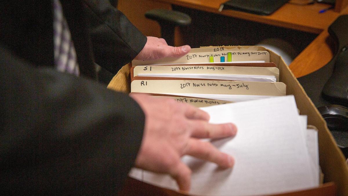 Tarrant County Sheriff’s Office Detective Mike Weber flips through a box of files for one medical child abuse case at his office in the Tarrant County Plaza Building on Feb. 25, 2023. Weber has investigated 35 claims of medical child abuse, otherwise known as munchausen syndrome by proxy.
