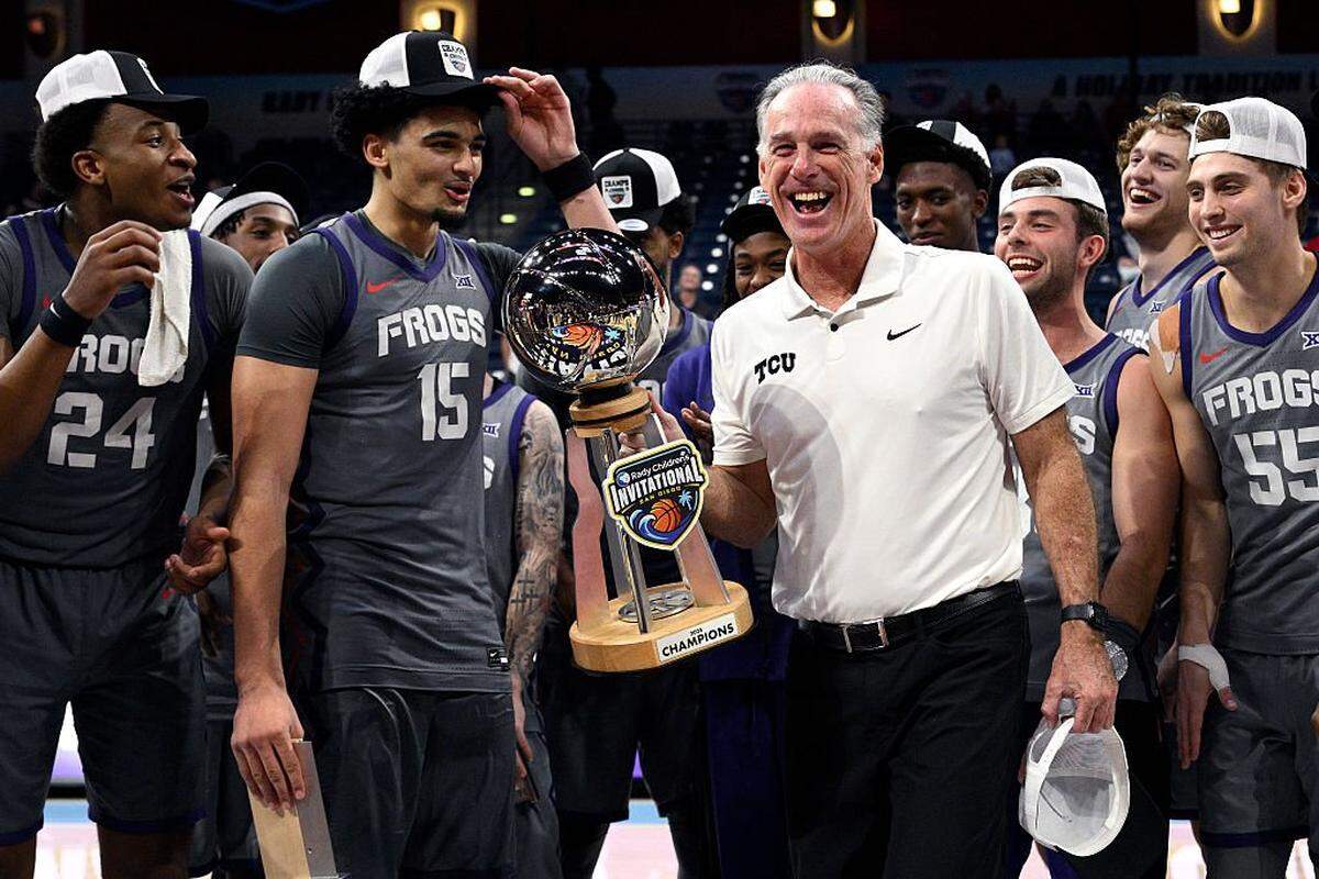 SAN DIEGO, CALIFORNIA - NOVEMBER 28: Head coach Jamie Dixon of the TCU Horned Frogs holds the winner's trophy after defeating the Wisconsin Badgers in the Rady Children's Invitational Championship game at Jenny Craig Pavilion on November 28, 2025 in San Diego, California. (Photo by Orlando Ramirez/Getty Images)