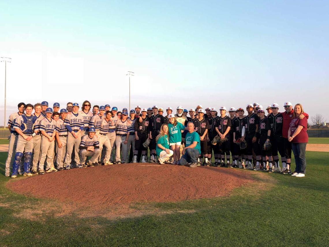 Khloe Brandon, 9, throws out the first pitch during the Keller Central baseball game, Tuesday March 19, 2019.
