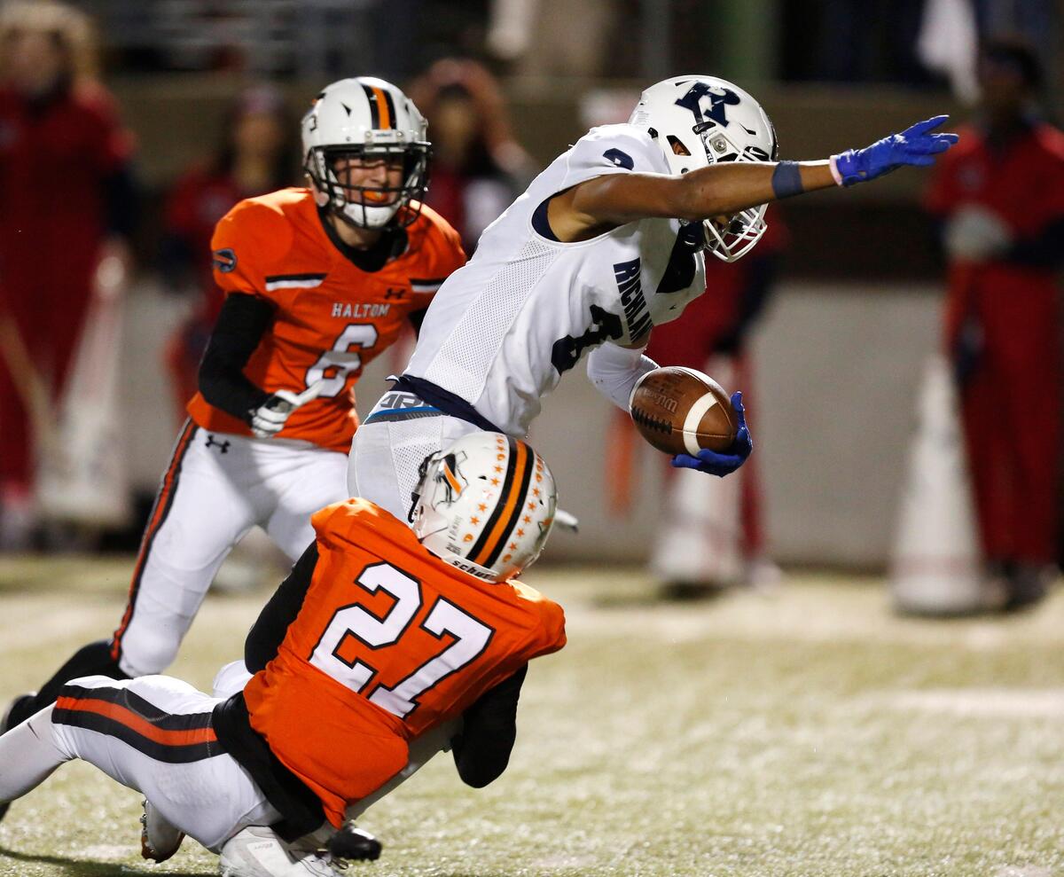 Richland’s C.J. Baskerville (3) runs with a catch in the fourth quarter, tackled by Haltom’s Julius Hare (27). The Richland Rebels played the Haltom Buffalos at Birdville FAAC stadium in North Richland Hills Friday, October 25, 2019.