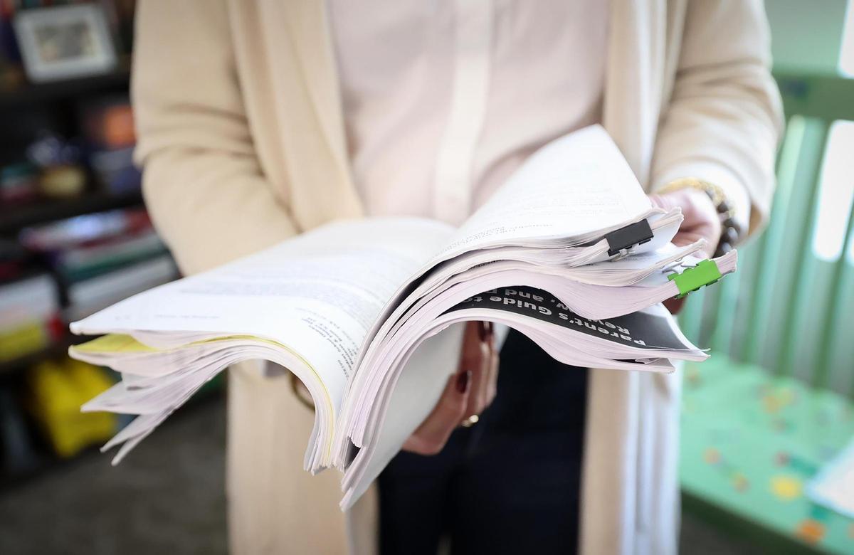 Caroline James flips through a stack of paperwork from Individualized Education Program (IEP) meetings concerning her son, Andrew, while he attended a Fort Worth Independent School District school. “They buried me in paper every time we had a meeting,” said James. She eventually transferred Andrew to Key School and Training Center after the district failed to diagnose his dyslexia.