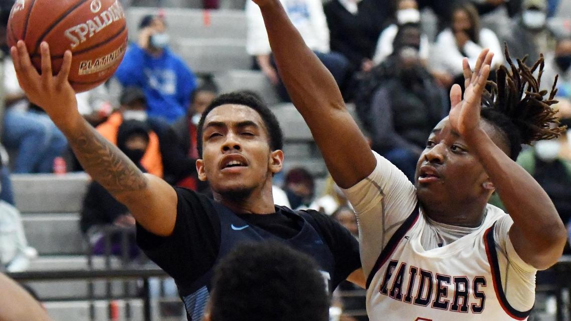 O.D. Wyatt’s Jacobi Lewis,left, lays up the basketball past Ryan’s Isaiah Novil in the fourth period of their 5A Region I Area playoff game Thursday, February 25, 2021 at Colleyville Heritage High School in Colleyville, Texas. Wyatt went on to win 59-44. Special/Bob Haynes