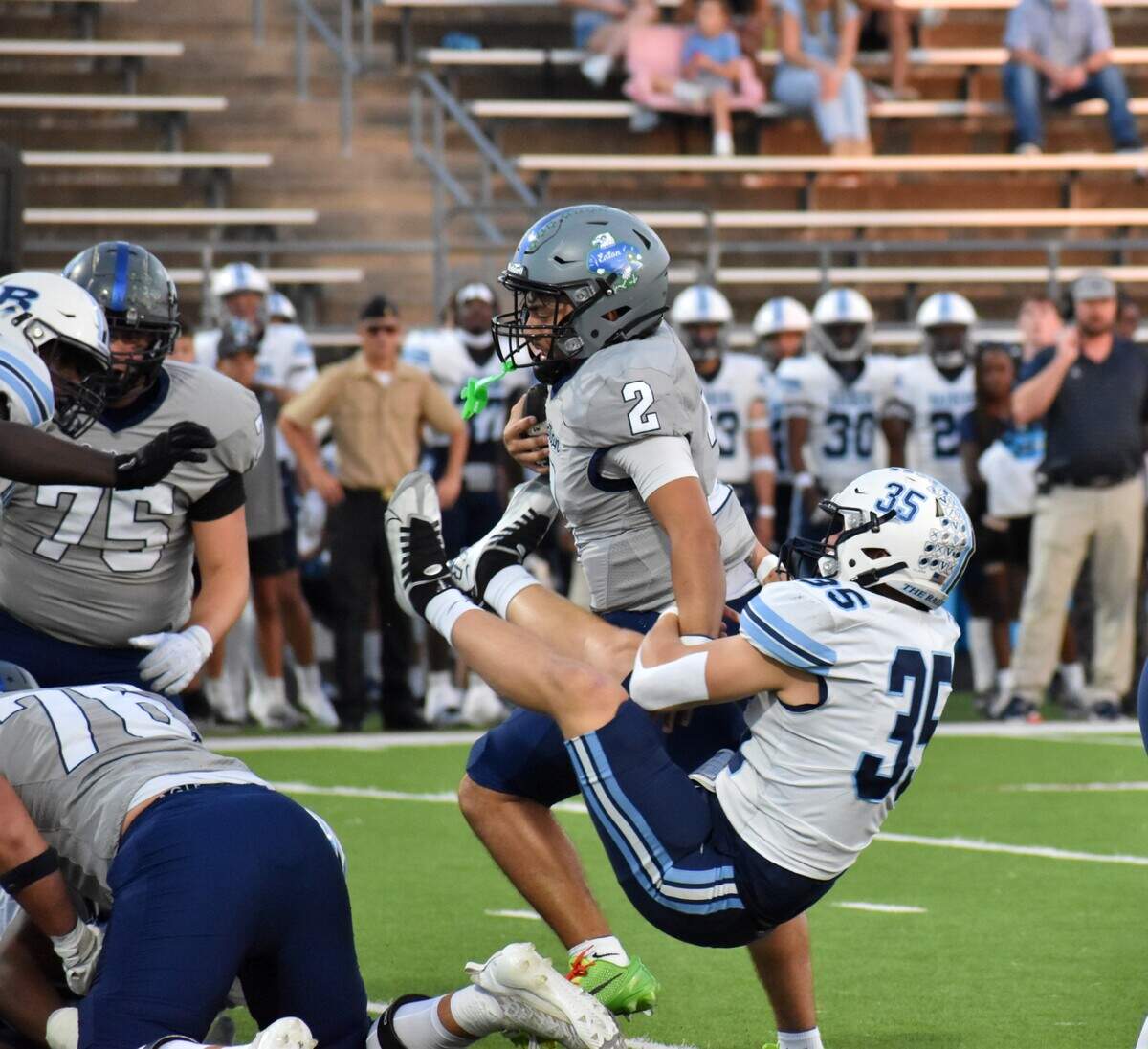 Hurst LD Bell linebacker Bradyn Clark (35) tries to bring down Haslet V.R. Eaton quarterback Kalika Nisa in the first quarter of a UIL high school football Class 6A game at Northwest ISD Stadium in Justin on Friday, Sept. 26, 2025.