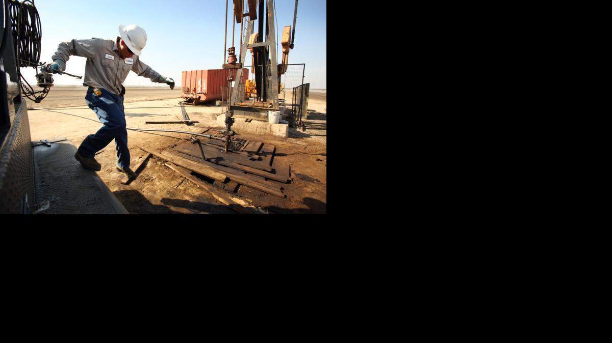
The price of oil jumped up Friday on indications on expectations of lower supplies since the number of working drilling rigs continues to fall. Aaron Kent, a wireline operator for Canary, LLC works on a slick line at an oil rig pump jack site in the oil fields near Bakersfield in March 2013.
