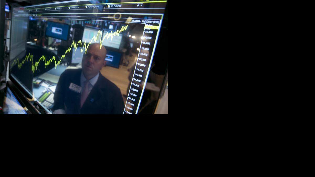 
Even after a poor start in January and a big wobble in October, the market climbed double digits. The solid gain pushed the bull-run for stocks into its sixth year, the longest since the 1990s. In July, specialist Jay Woods was reflected in a screen at his post that shows five years of the Dow Jones industrial average, on the floor of the New York Stock Exchange.


