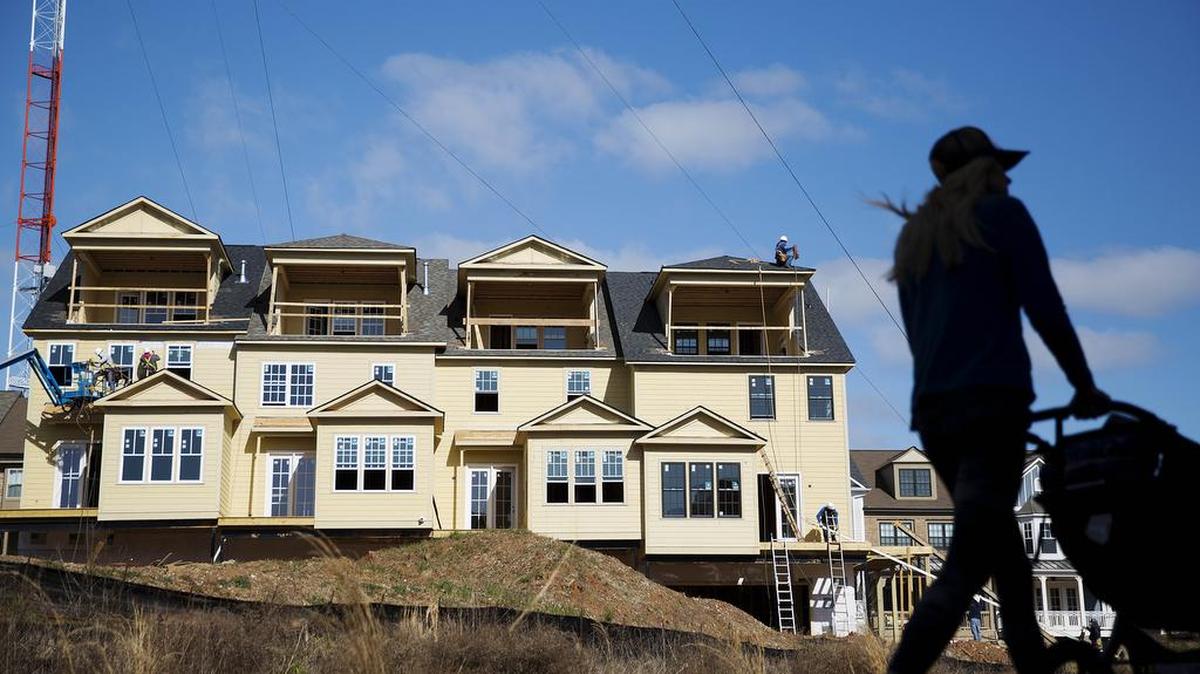 Town homes stand under construction as a pedestrian walks along the BeltLine in Atlanta. Standard & Poor’s/Case-Shiller said its 20-city home price index rose 5.7 percent in January.