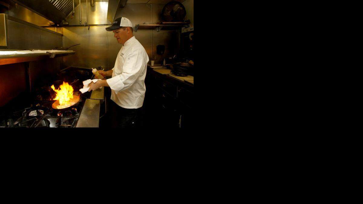 
Brian Olenjack on the grill at Olenjack’s Grille in April 2014. The chef has parted ways with the Arlington restaurant he founded in 2007.
