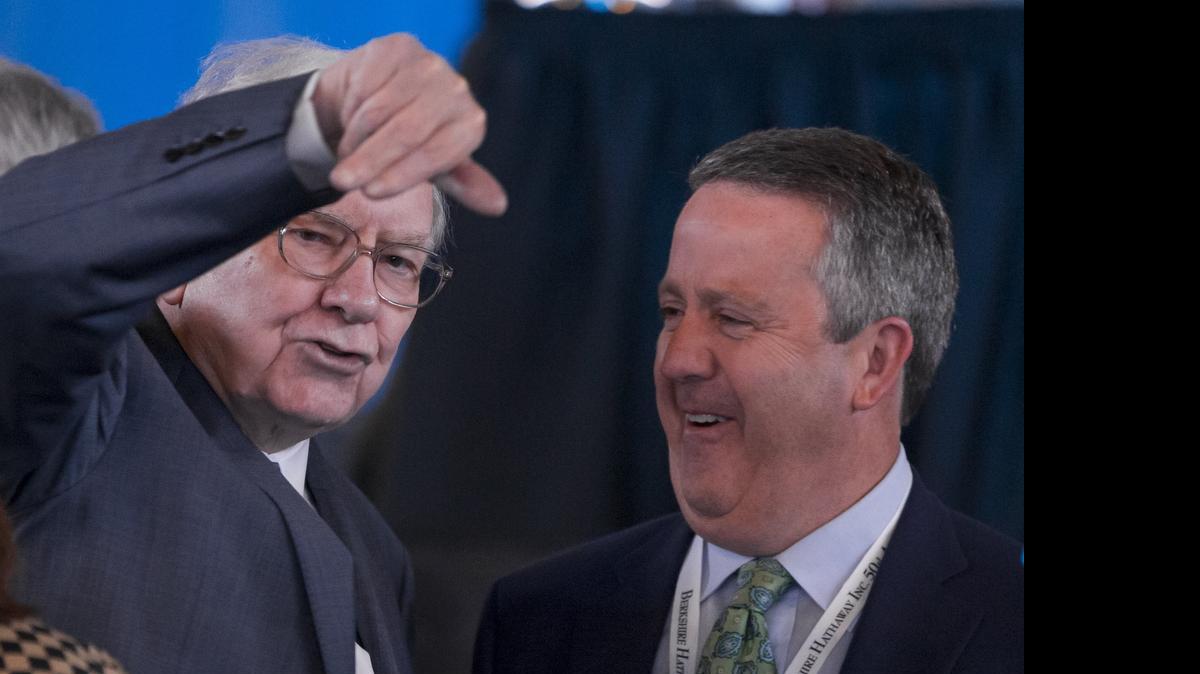 
Warren Buffett, left, talks to BNSF Railway’s executive chairman Matt Rose before the annual Berkshire Hathaway shareholder meeting in Omaha, Neb., on Saturday, May 2. 
