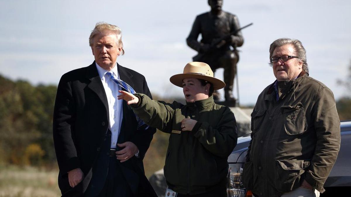 Interpretive park ranger Caitlin Kostic, center, gives a tour near the high-water mark of the Confederacy at Gettysburg National Military Park to Republican presidential candidate Donald Trump, left, and campaign CEO Steve Bannon, Saturday in Gettysburg, Pa.