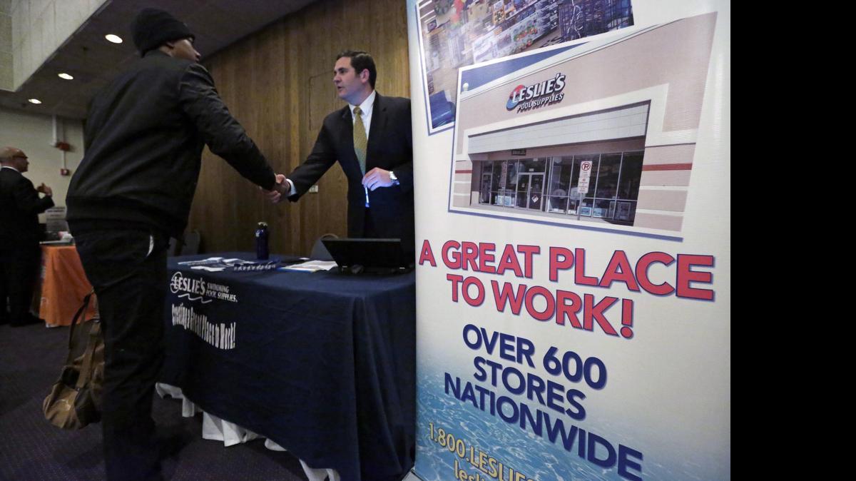 
A recruiter for Leslie’s Pool Supplies meets a candidate at a National Career Fairs job fair in Chicago. U.S. employers added 223,000 jobs in April. 
