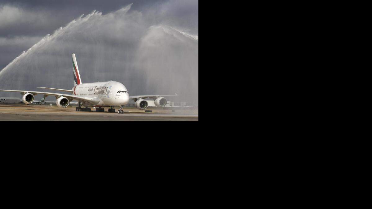
A ceremonial water spray welcome from DFW fire trucks. Emirates Airline's A380, the most luxurious aircraft in the world with on-board shower spas and a bar for first class passengers, landed at DFW AirportOctober 1, 2014. 
