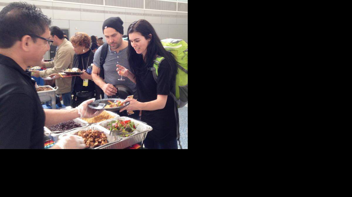 
Dominique Therie and Patricia Blabrie of Montreal sample free fare from a Qdoba Mexican food restaurant Tuesday at Dallas/Fort Worth Airport, before changing planes for their vacation flight to Puerto Vallerta, Mexico. Several DFW Airport eateries took part in a “Healthy+Happy” campaign to let travelers know about low-calorie options available in the passenger terminals. 
