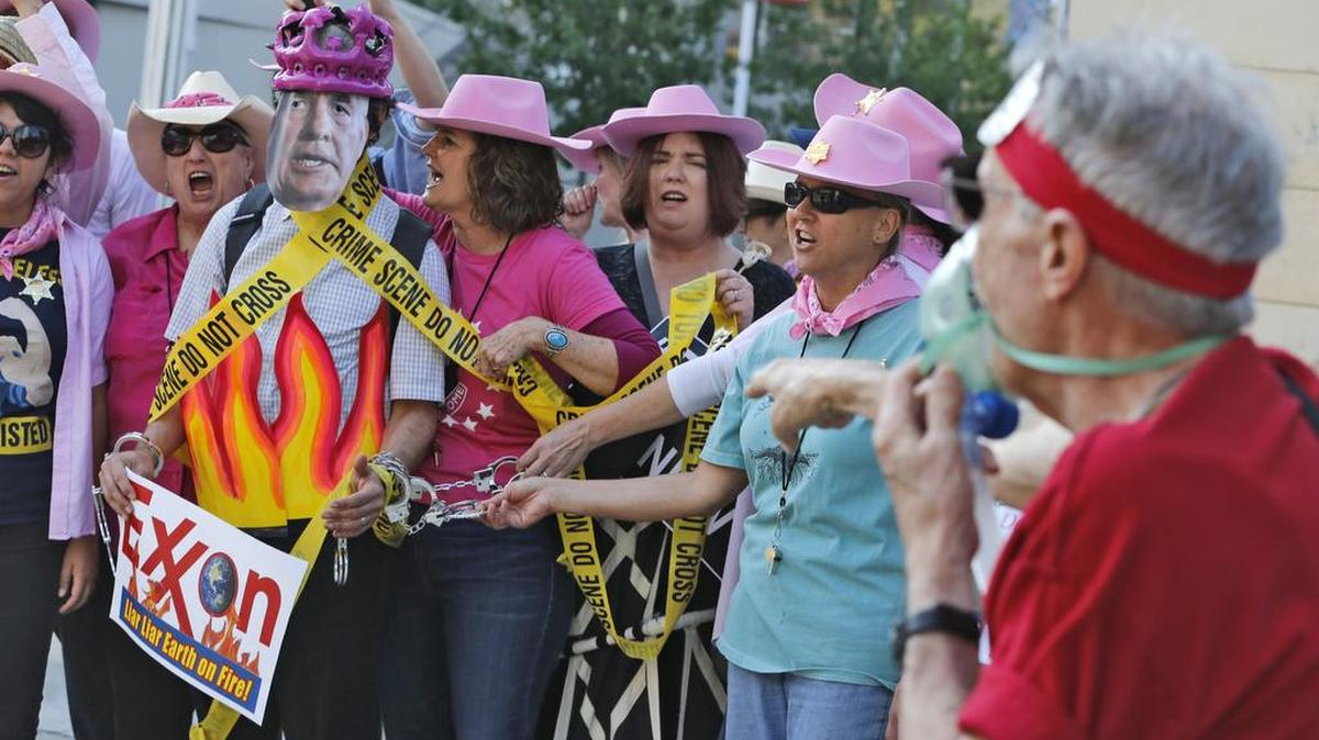 The New York Attorney General’s office contends Exxon Mobil has misled investors on climate control. Members of Code Pink protested during the Exxon shareholders meeting in Dallas last week.
