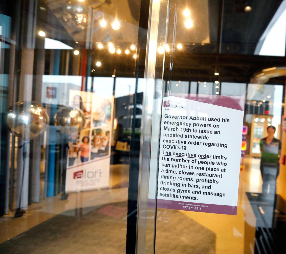 A sign details Texas Governor Greg Abbott’s executive order at the entrance of the Aloft Dallas Hotel in Euless.
