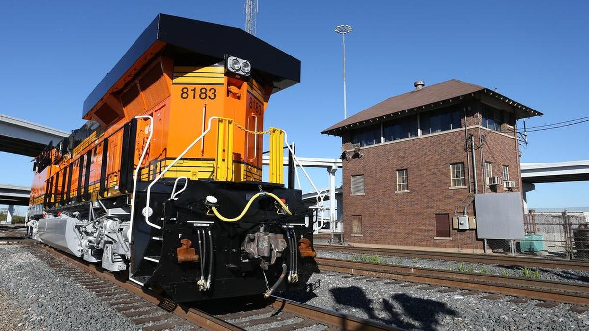 BNSF is furloughing about 4,600 employees nationwide. In this photo, a BNSF locamotive passes the old Tower 55 in downtown Fort Worth.