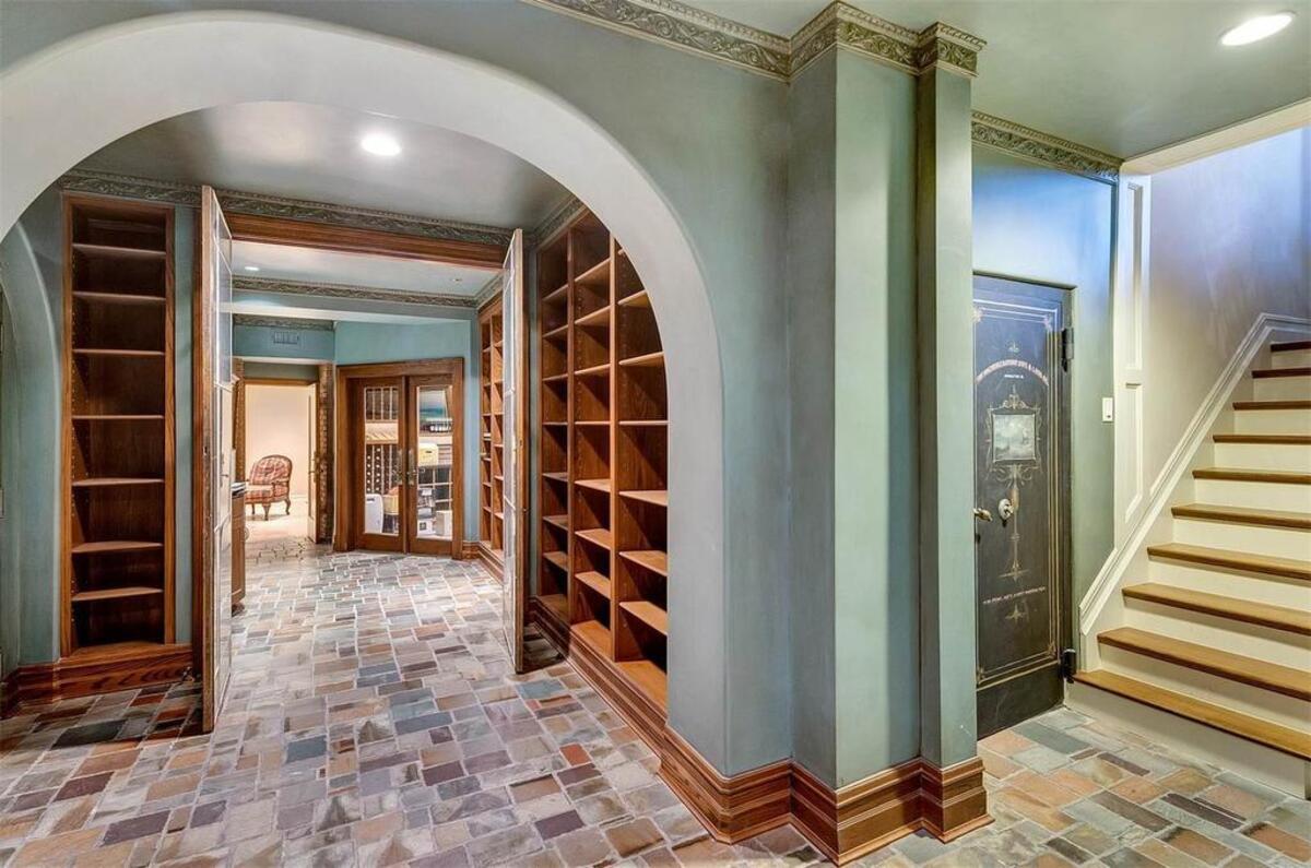 The ornate vault door, leading to what is now the media room, can be seen at the bottom of the steps.