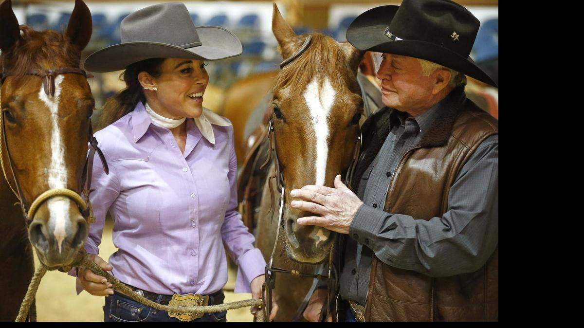 
Stacie and David McDavid with their horses between rides at the NCHA Super Stakes competition in Fort Worth.
