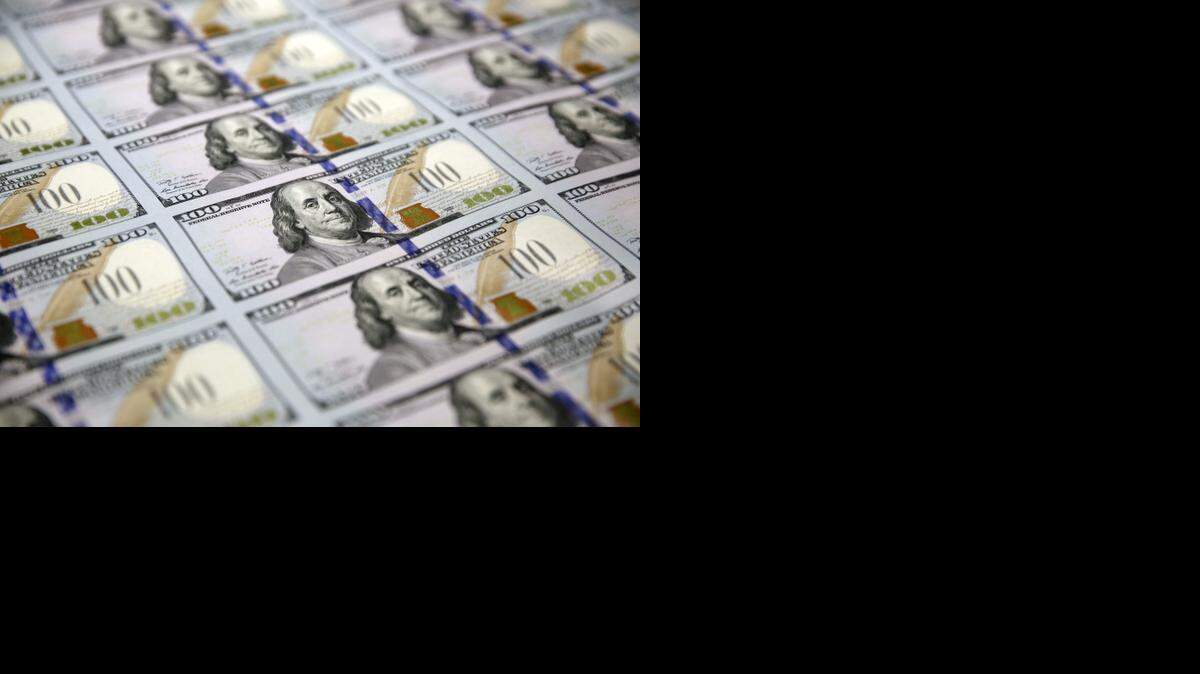 
Federal Reserve policymakers begin a two-day meeting to set interest rates on Wednesday. In this September 2014 photo a sheet of uncut $100 bills makes the way through the printing process at the Bureau of Engraving and Printing Western Currency Facility in Fort Worth.



