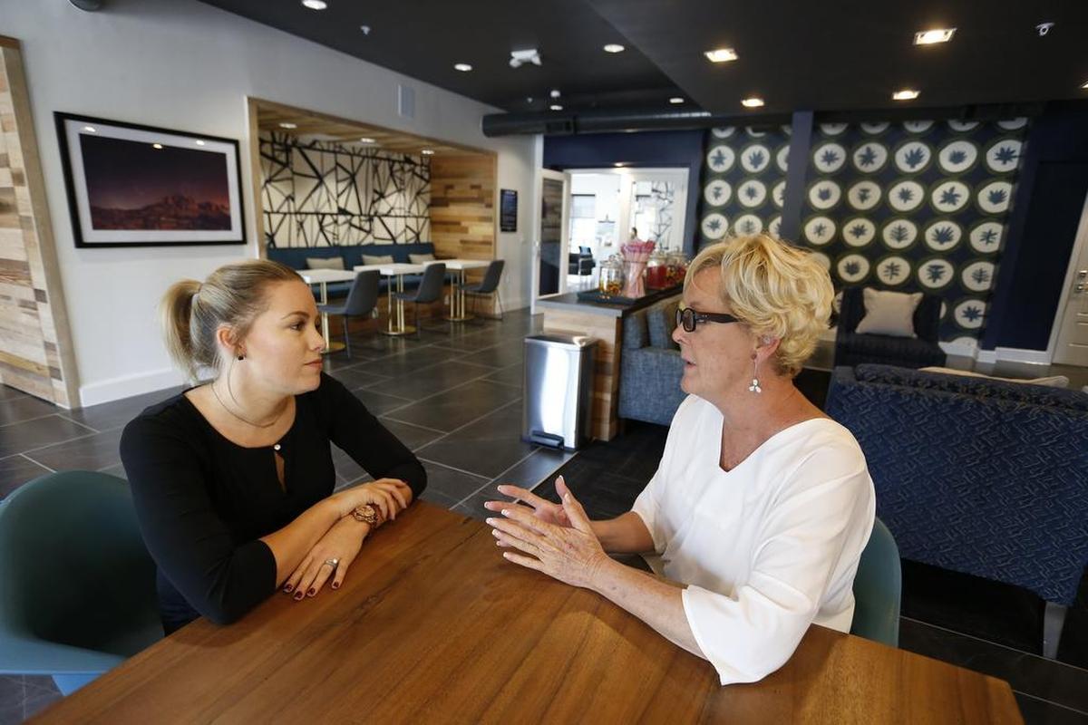Rachel Riviello, left, and Rhonda McLaughlin, a relocation specialist with Bridge Residential Property Services, meet at the high-end commons area for residents of The Flats at Alta Left Bank.