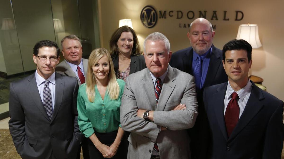 Attorneys from Dan McDonald’s law firm and the Circelli, Walter & Young have parted ways over the Chesapeake Energy lawsuits. McDonald is fifth from the left, George Parker Young is sixth.