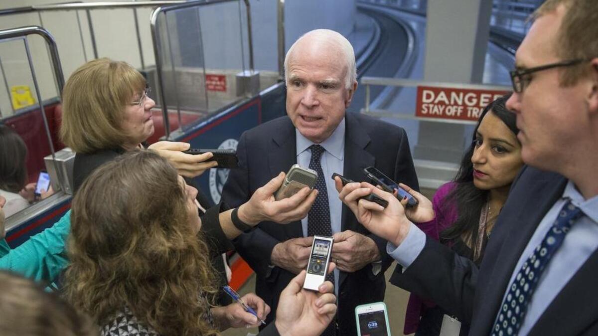 Senate Armed Services Committee Chairman Sen. John McCain, R-Ariz., surrounded by reporters in Washington.