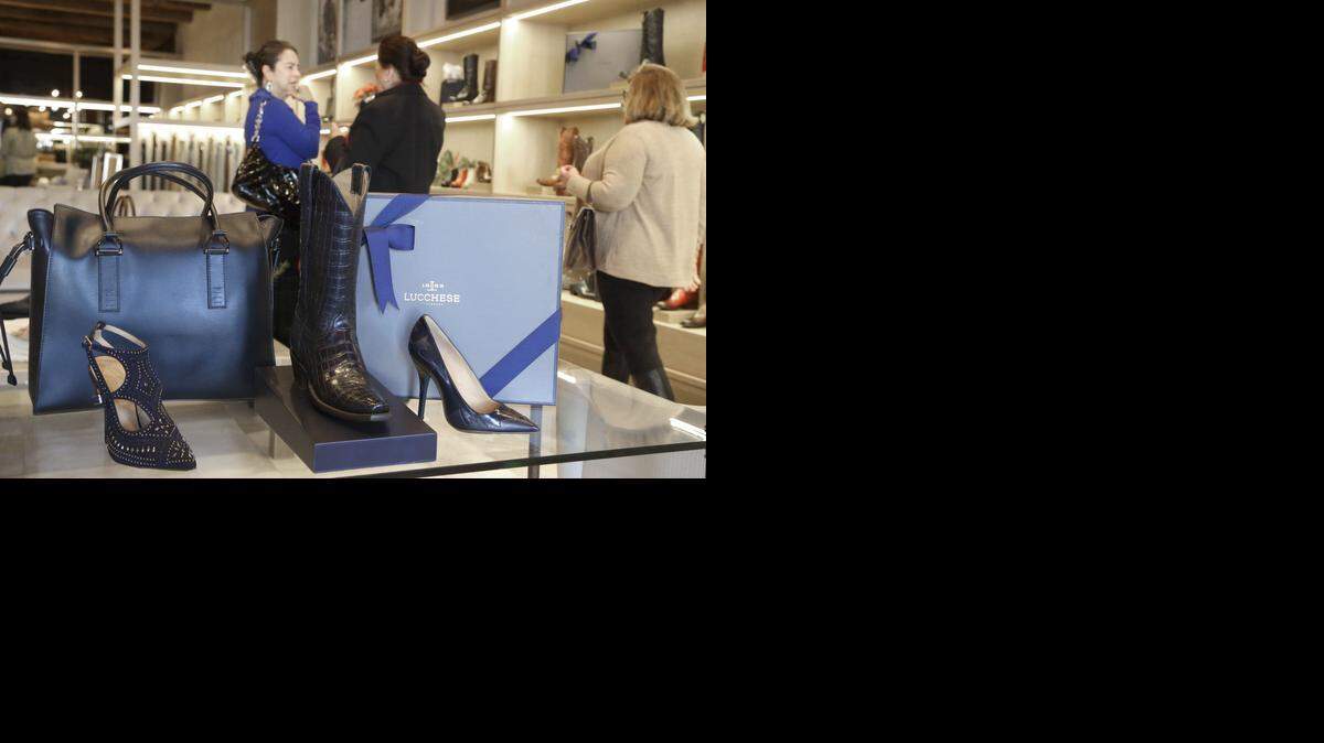 
A traditional boot is flanked by stiletto heels in a display at the Lucchese Bootmaker shop in Houston.


