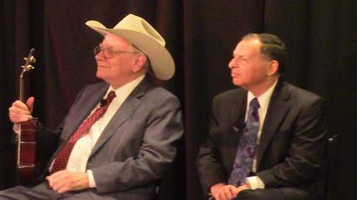 
Warren Buffett, wearing a cowboy hat, holds the ukulele he played at a cancer charity event at the new Nebraska Furniture Mart in The Colony on Wednesday, April 8, 2015. The autographed ukulele sold for $19,000 and Buffett matched the winning bid with a donation to Cancer Support Community North Texas.
