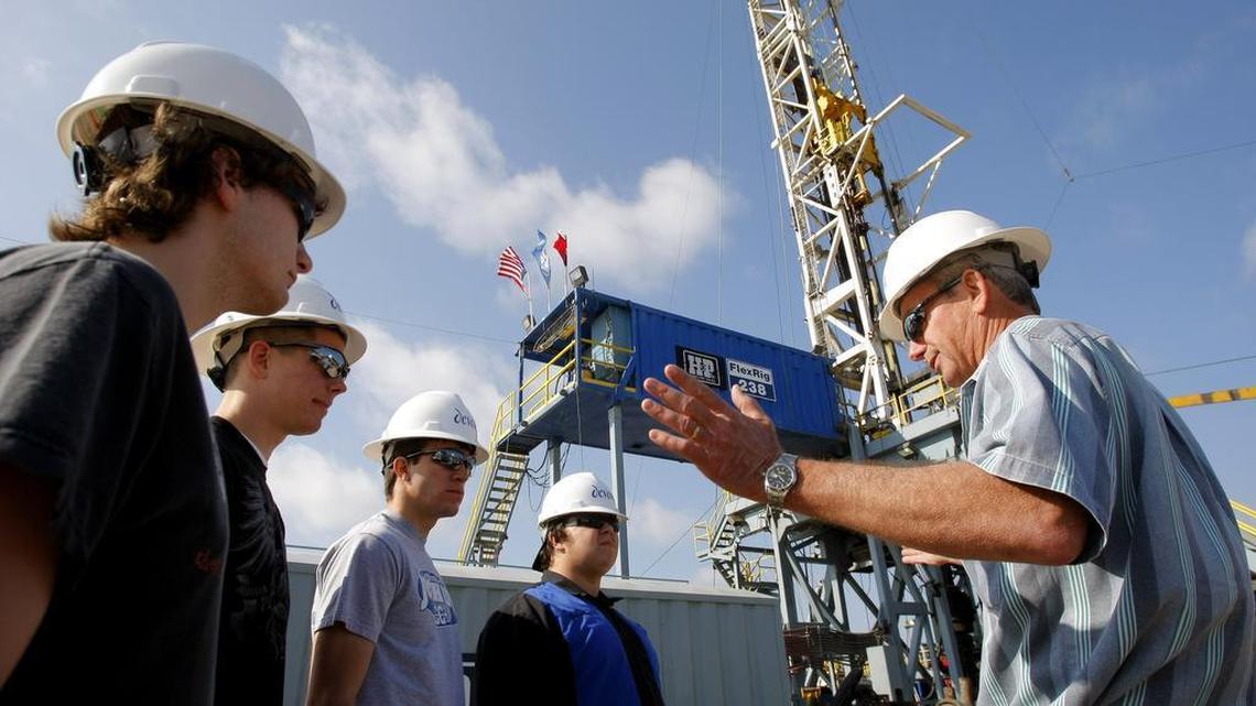 Devon Energy is accused of underpaying royalty owners for natural gas produced in North Texas. In this archive photo from 2009, Joshua High School students visit a drilling site in Johnson County.