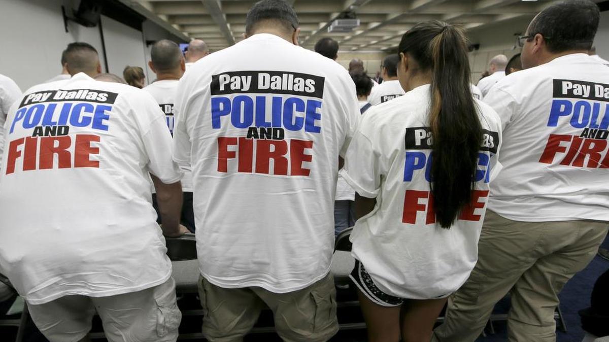 Dallas police and firefighters fill the gallery for a city council budget meeting in August 2016 at Dallas City Hall in Dallas. Texas Gov. Greg Abbott recently signed two bills aimed at fixing troubled pensions in Dallas and Houston respectively. Both are projected to have billions of dollars in unfunded liabilities that could have caused them to go broke in a decade or less.