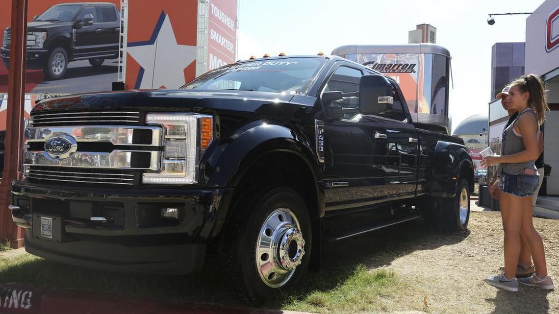 Visitors look at a fully-loaded F-450 Super Duty Limited, the biggest version of the Ford F-Series, on display at the State Fair of Texas in Dallas.