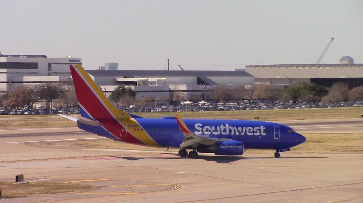A Southwest Airlines plane taxis at Dallas Love Field in front of the carrier’s headquarters.