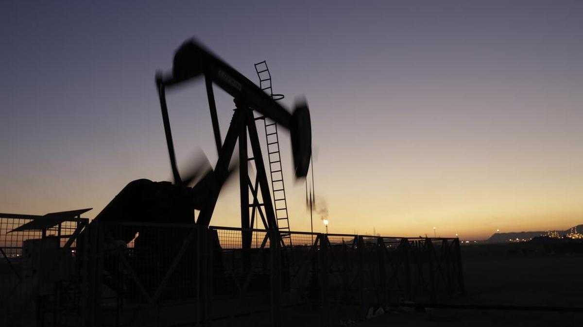 An oil pump works at sunset in the desert oil fields of Sakhir, Bahrain. Iran is aiming to increase its oil production by 500,000 barrels per day now that sanctions have been lifted.