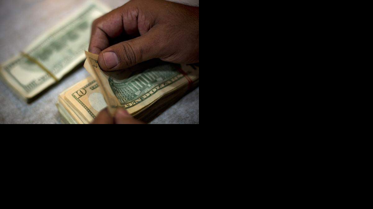 
Cutting back on loans being offered at some stores, and customers having cash in their pockets from lower gas prices, hurt Cash America’s business



