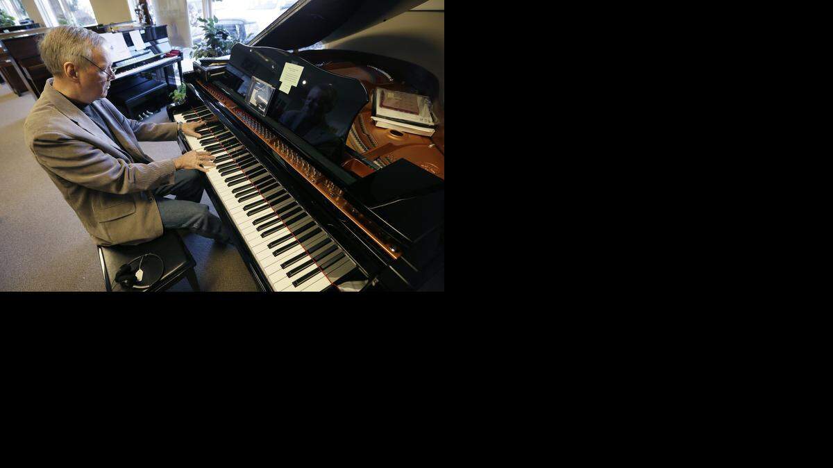 
Jim Foster plays a grand piano in his Foster Family Music Center piano store in Bettendorf, Iowa. The number of stores dedicated to selling pianos is dwindling across the country as fewer people take up the instrument and those who do opt for a used piano or a less expensive electronic keyboard.


