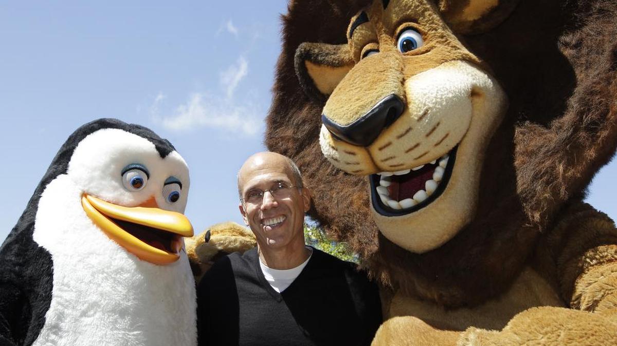 DreamWorks Animation CEO Jeffrey Katzenberg, center, plays with Madagascar characters, Alex the lion, right, and Kowalski the penguin. DreamWorks will become part of the Universal Filmed Entertainment Group, which includes Universal Pictures.