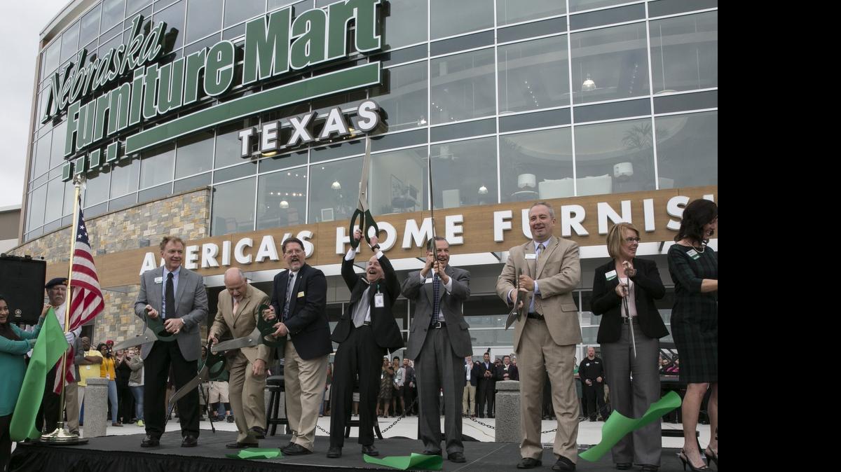 
Nebraska Furniture Mart employees and local officials cut the ceremonial ribbon during the Grand Opening in The Colony .
