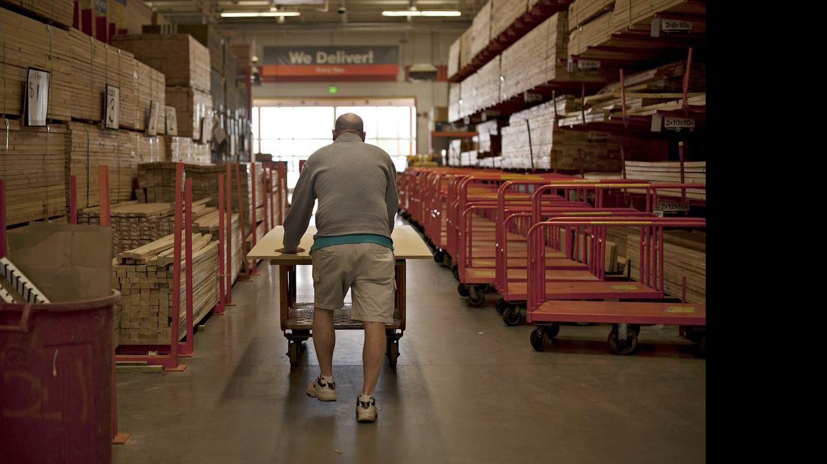 
A customer pushes a cart of lumber at a Home Depot Inc. store in Peoria, Ill. Providing an optimistic view on the U.S. housing market, Home Depot posted first-quarter profit that topped analysts’ estimates during the retailer’s most important selling season. 
