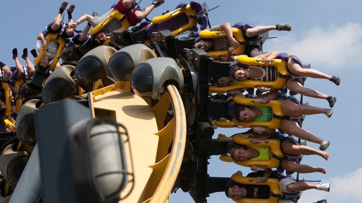 Excited visitors yell as they flip sideways on Batman: The Ride at Six Flags Over Texas theme park in Arlington.