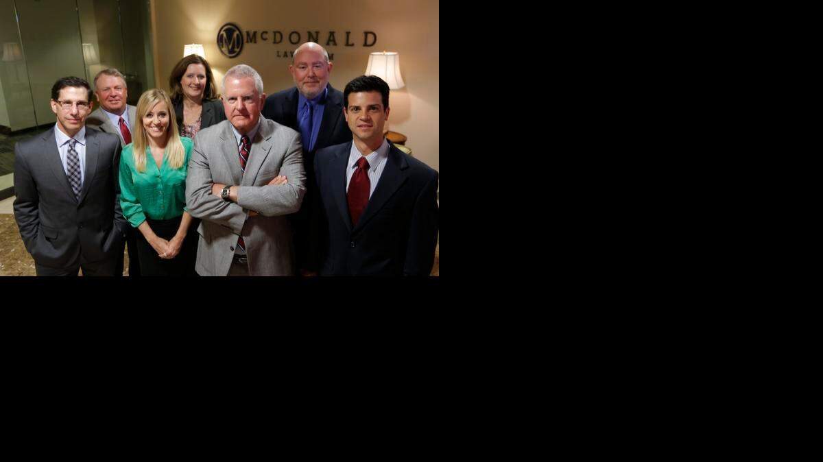 
An Oklahoma judge overseeing a class action settlement against Chesapeake has temporarily ordered Fort Worth attorney Dan McDonald and his law firm from interfering with the case. McDonald, third from the left, stands in his Fort Worth office with a team of lawyers.


