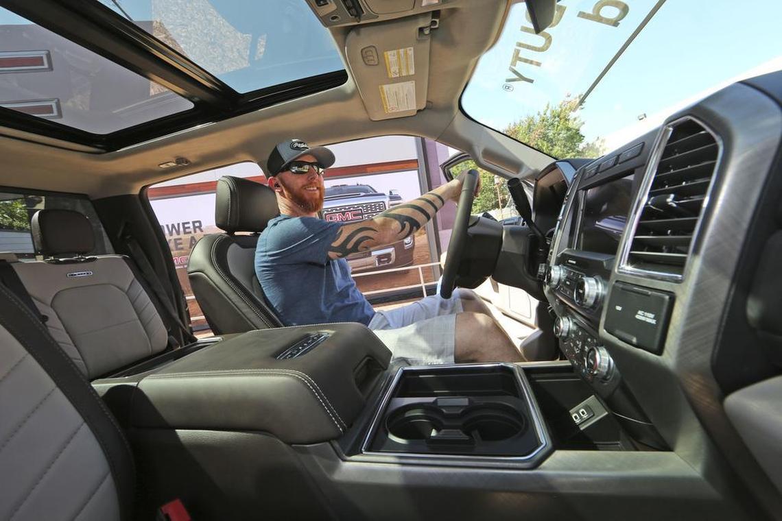 A man looks at the interior of a fully-loaded F-450 Super Duty Limited, the biggest version of the Ford F-Series, on display at the State Fair of Texas in Dallas.