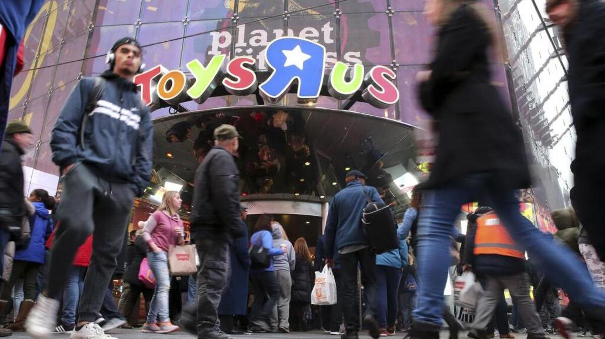 Visitors to New York’s Times Square walking past the Toys R Us store, which closed on Wednesday.