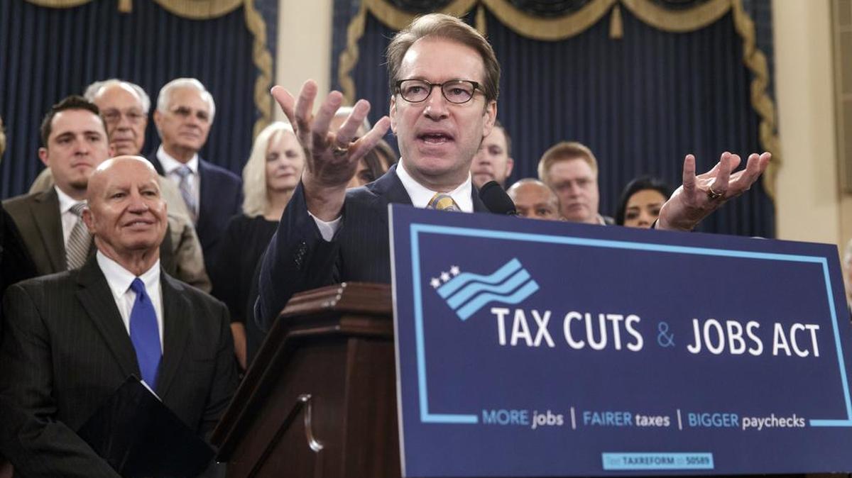Rep. Peter Roskam, R-Ill., chairman of the House Ways and Means Subcommittee on Tax Policy, joined at left by Ways and Means Chairman Kevin Brady, R-Texas, describes the GOP's far-reaching tax overhaul, the first major revamp of the tax system in three decades.
