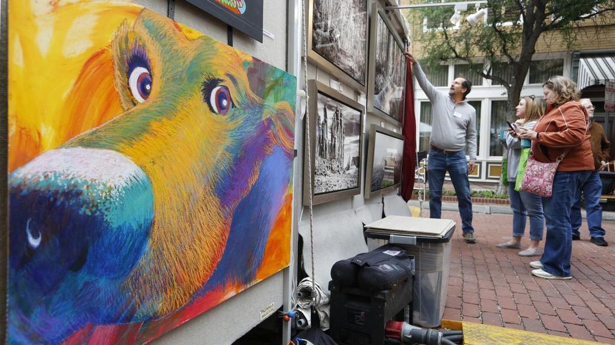 Visitors to the Main Street Fort Worth Arts Festival admire artwork on Saturday April 22, 2017.